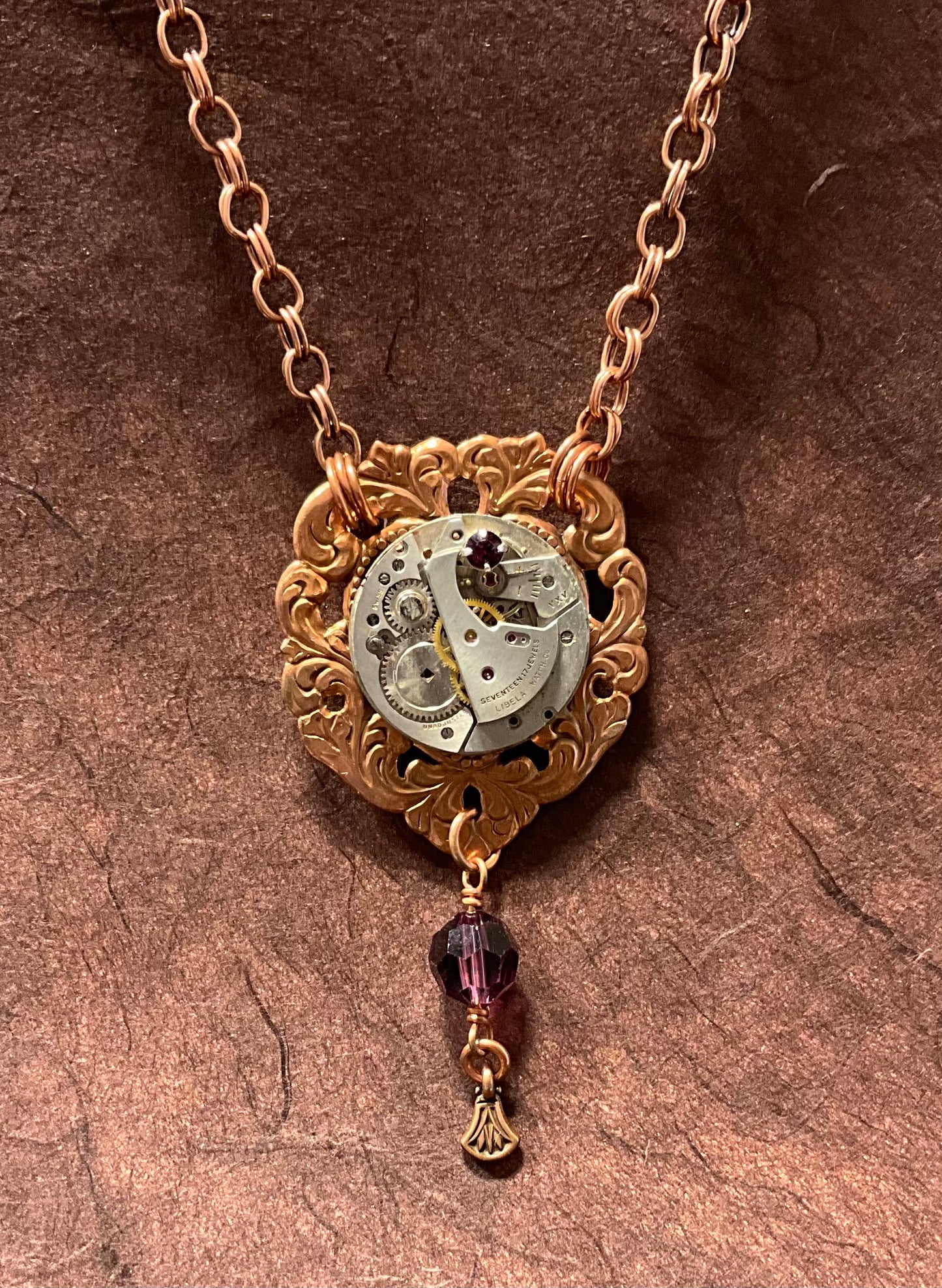 copper necklace with vintage watch and purple crystals
