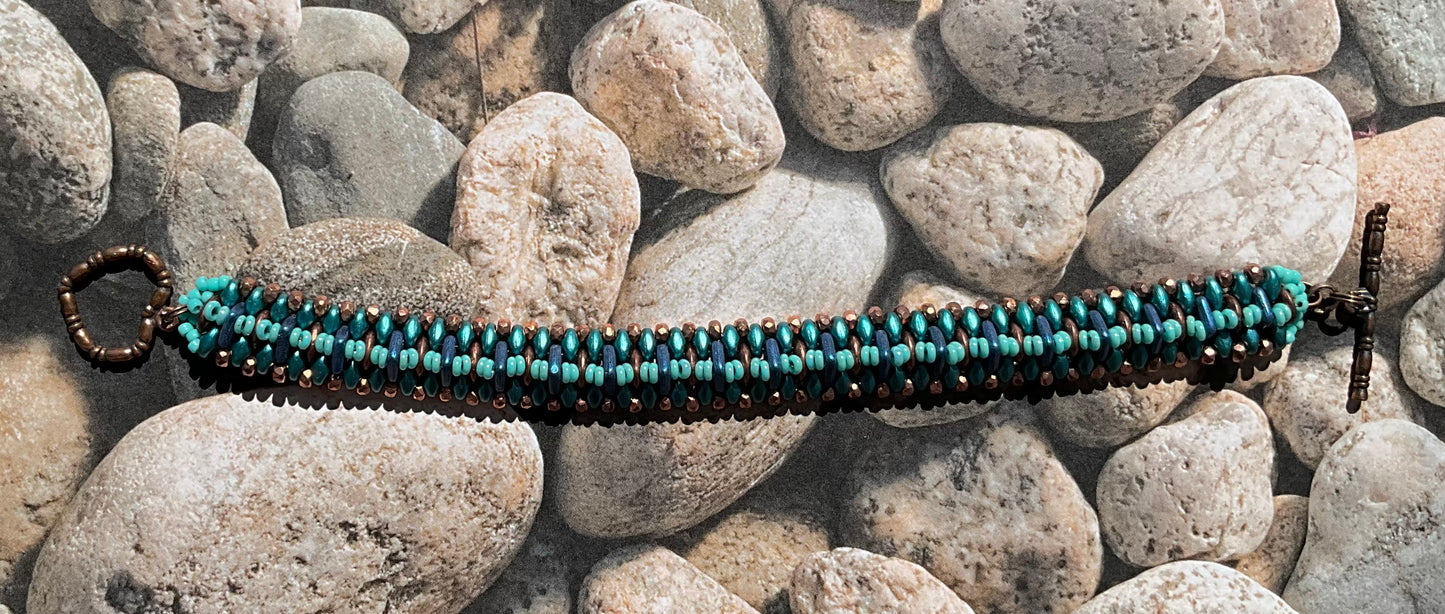 woven beaded bracelet in teals, copper and blue