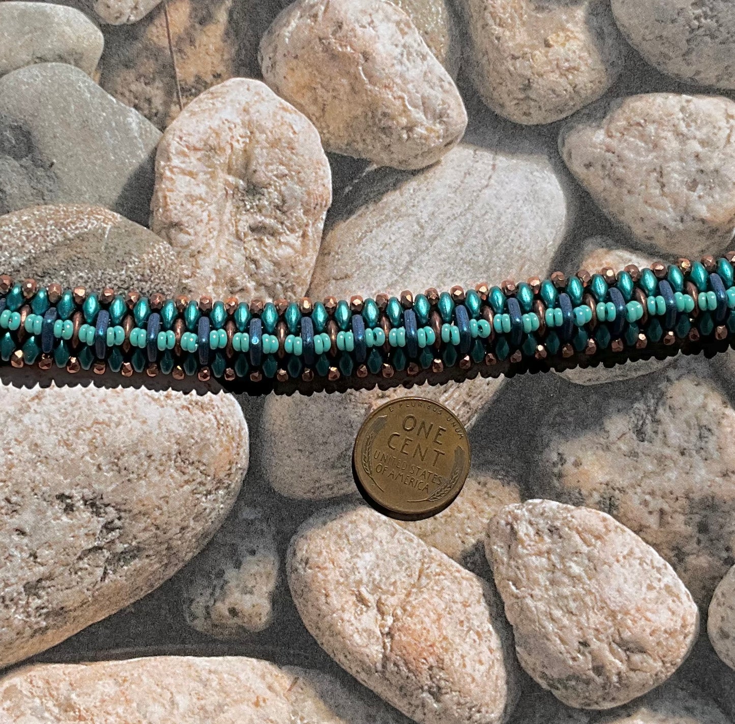 woven beaded bracelet in teals, copper and blue