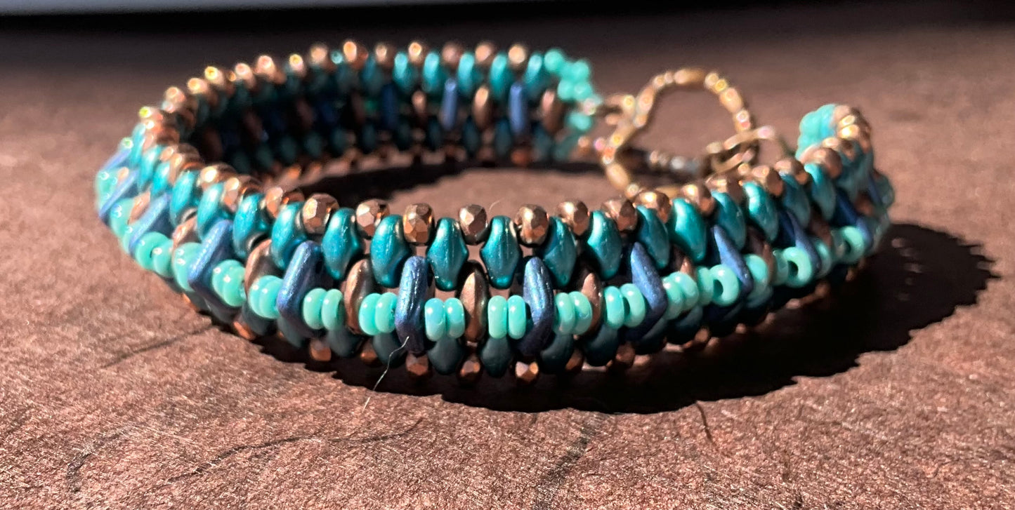 woven beaded bracelet in teals, copper and blue