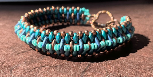 woven beaded bracelet in teals, copper and blue