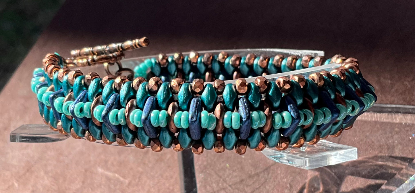 woven beaded bracelet in teals, copper and blue