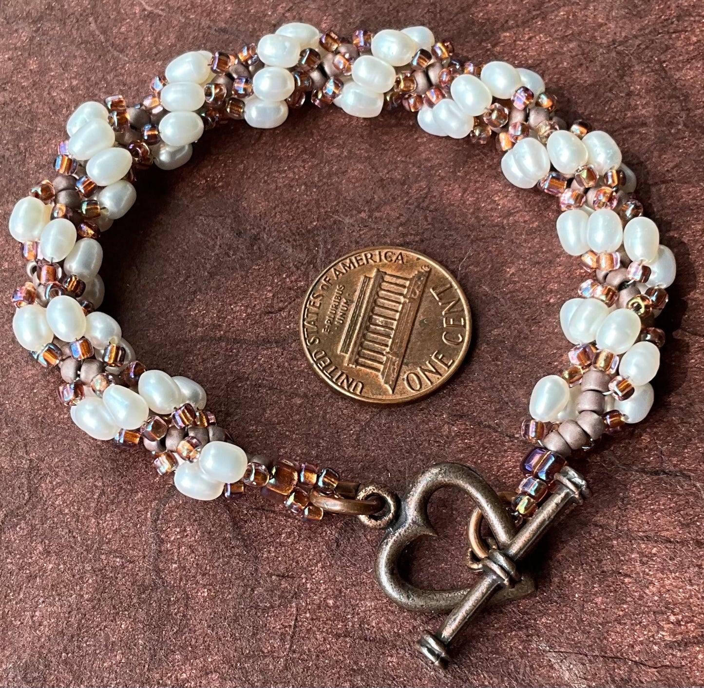 Spiral bracelet featuring pearls
