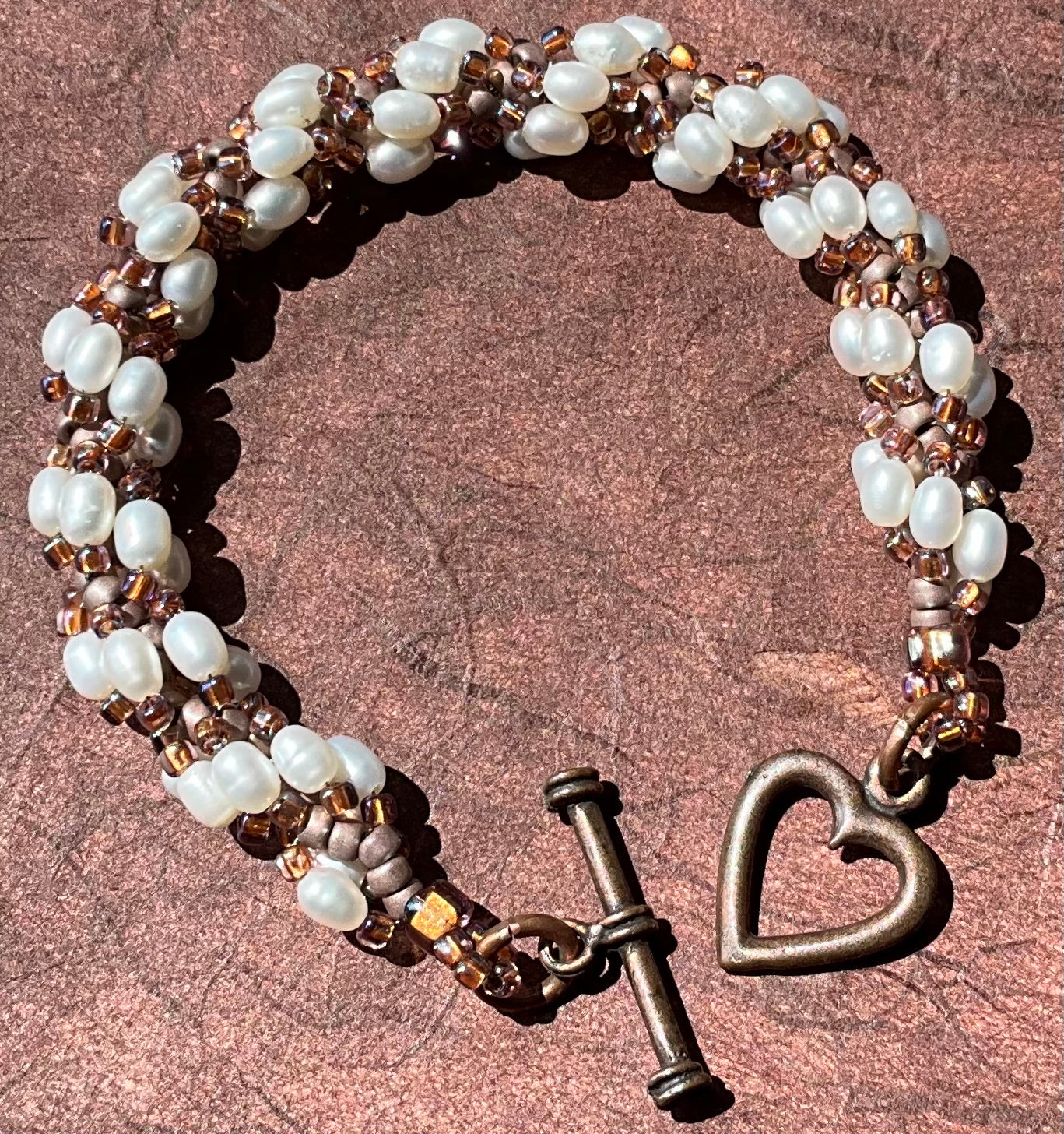 Spiral bracelet featuring pearls