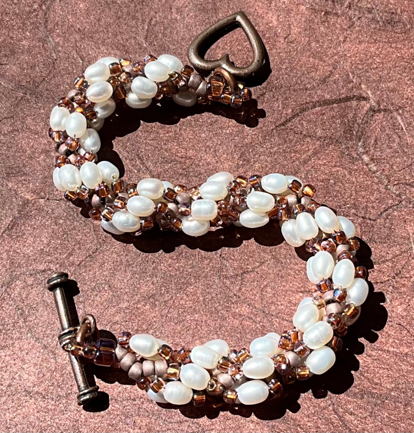 Spiral bracelet featuring pearls