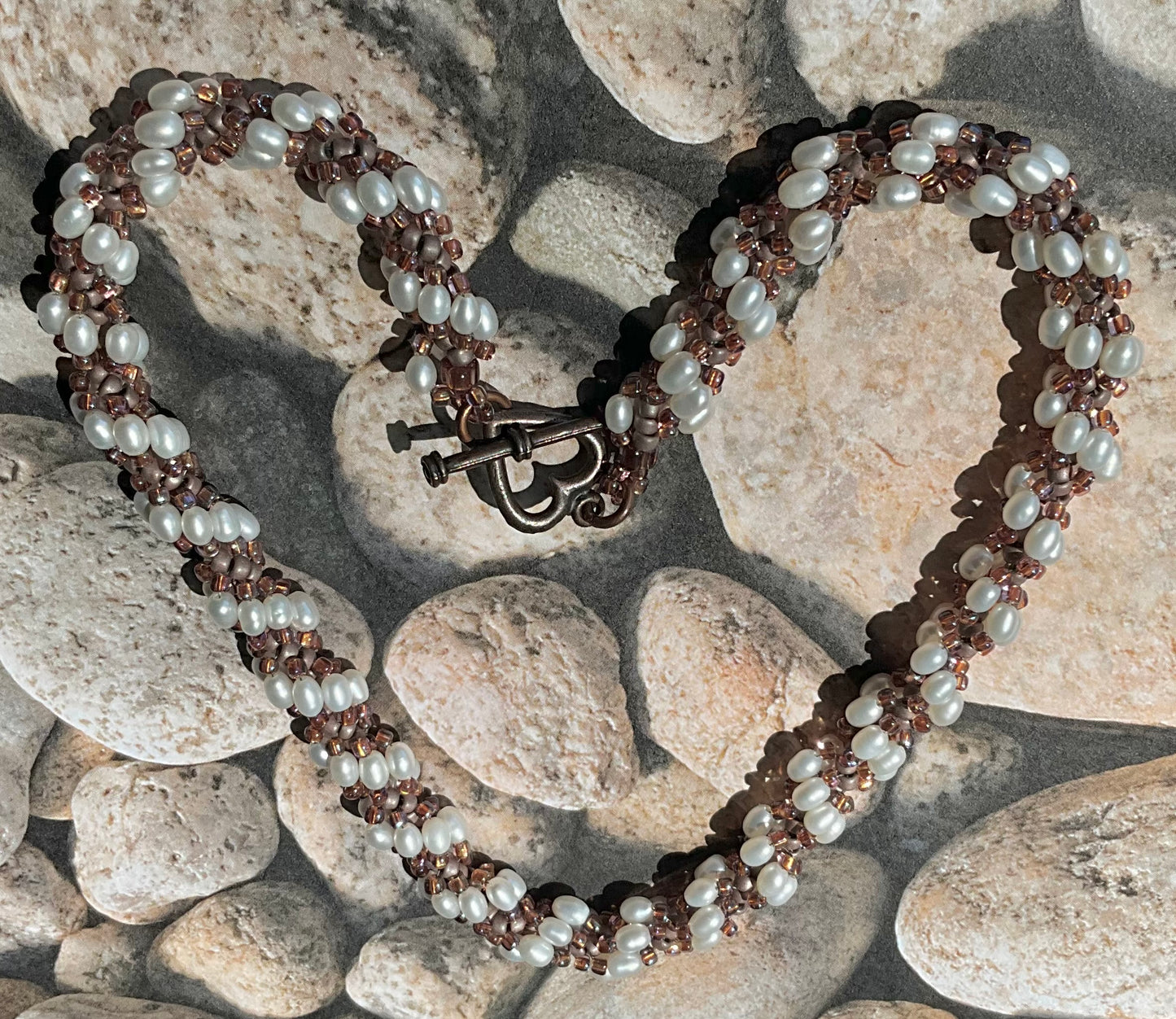 Spiral necklace featuring pearls