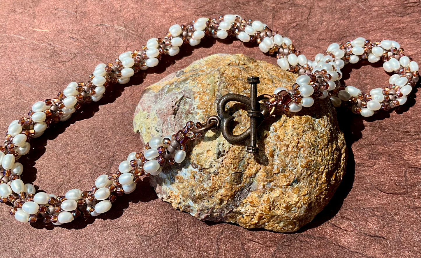 Spiral necklace featuring pearls