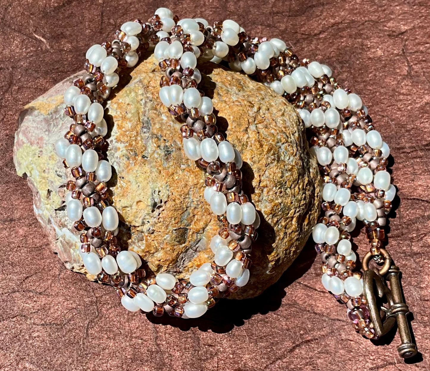 Spiral necklace featuring pearls