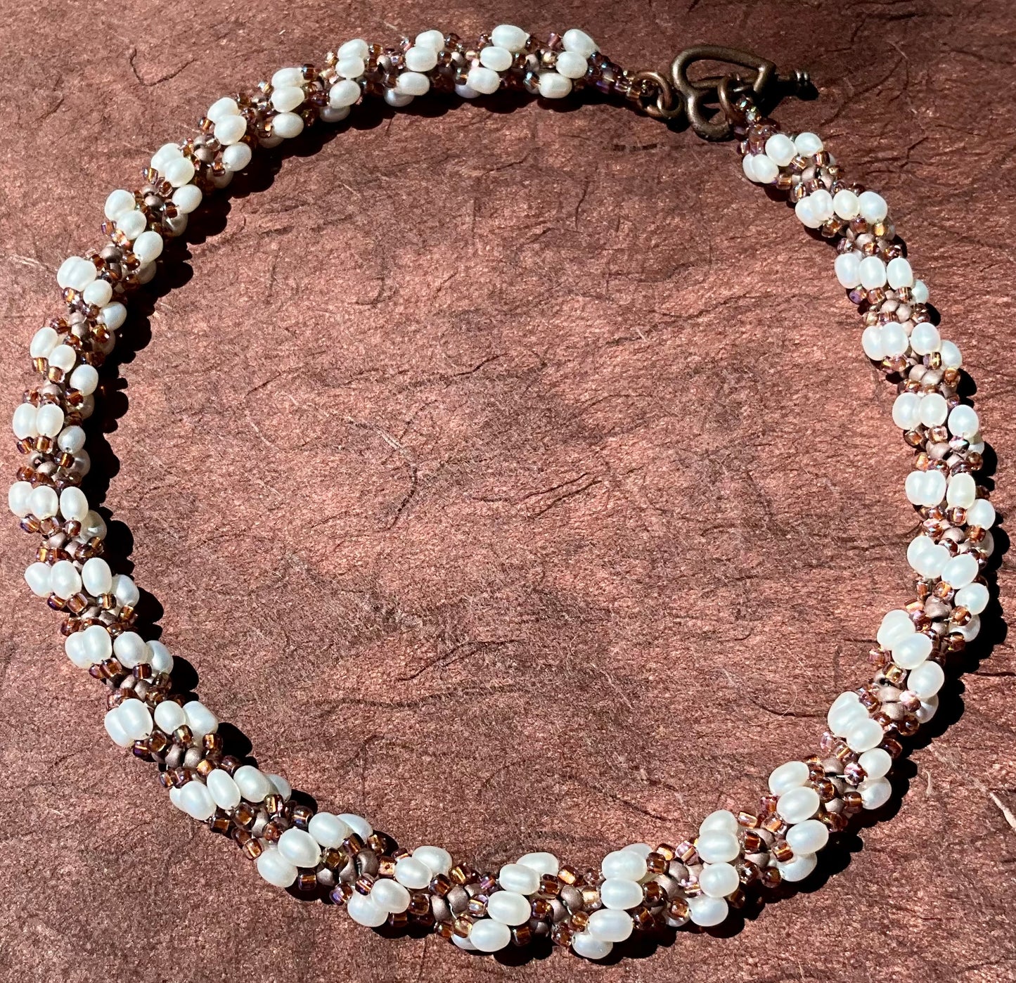 Spiral necklace featuring pearls