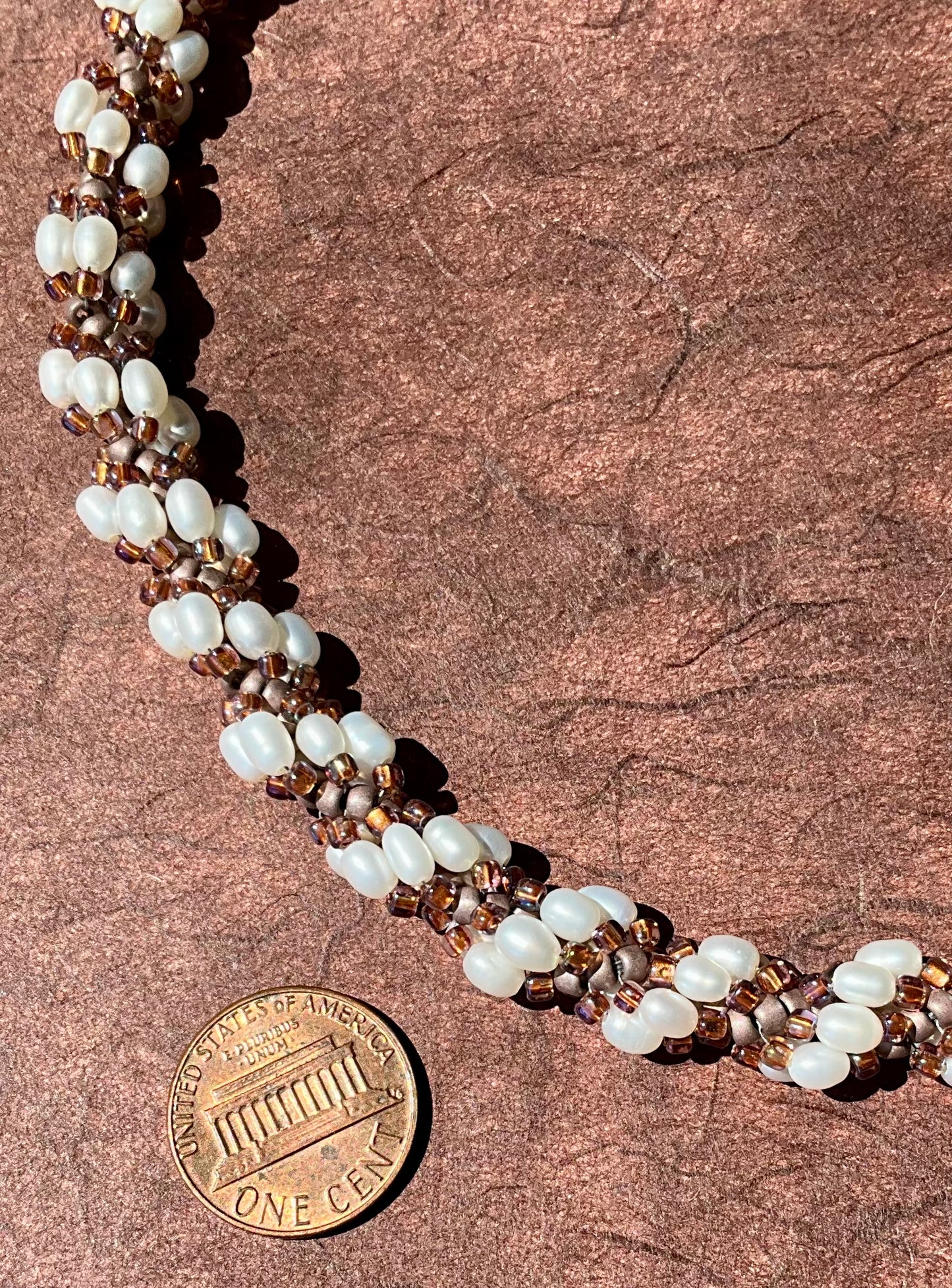 Spiral necklace featuring pearls